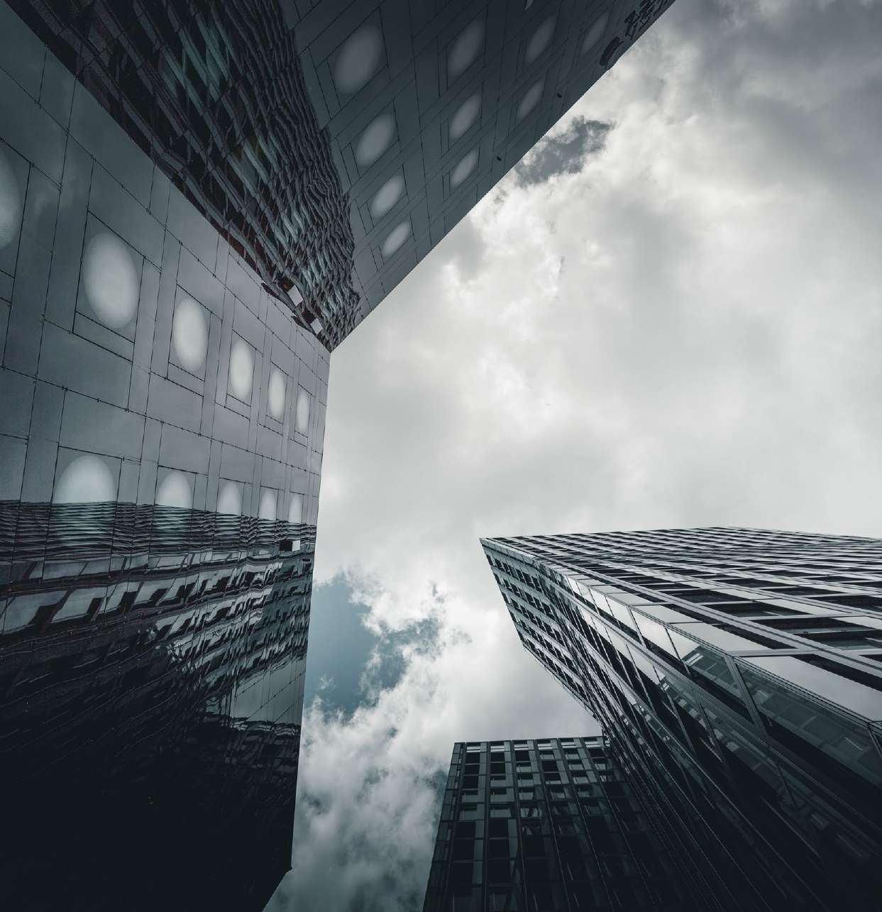 Skyscrapers seen from below against clouds