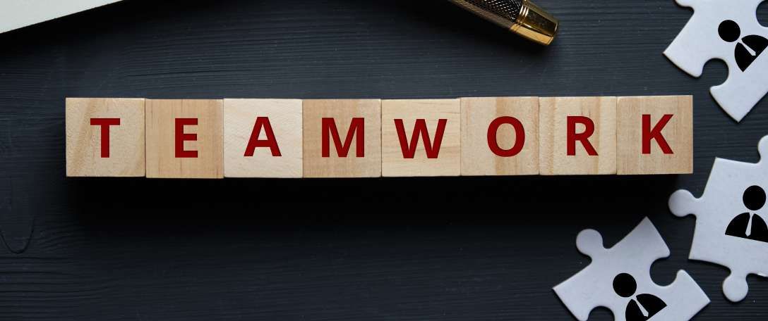 Wooden letter blocks spelling TEAMWORK